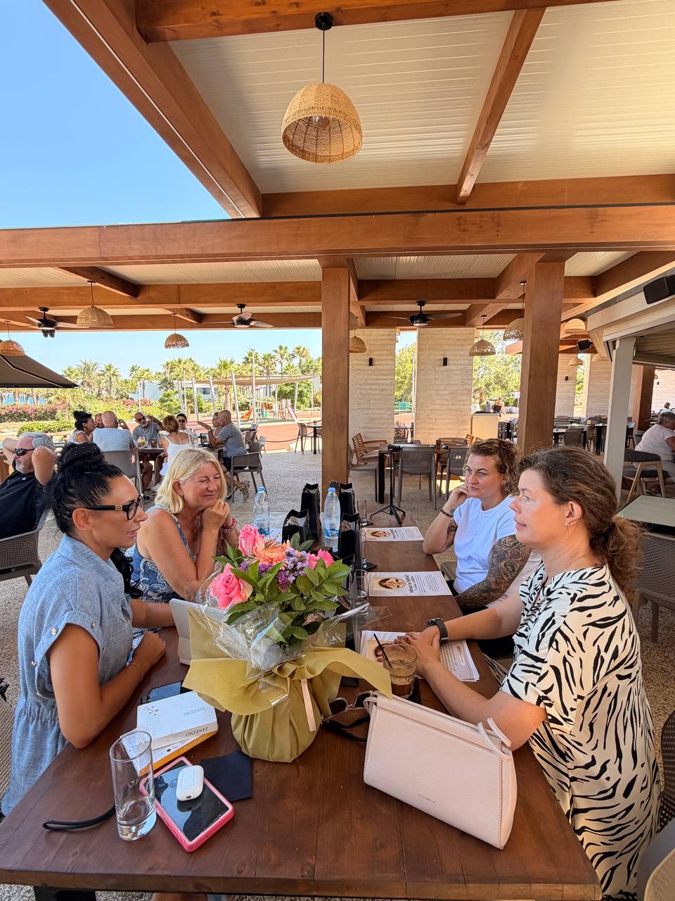 The women of WPA at the table overlooking the sea at George & Xenia Beach Bar, 10 July 2026