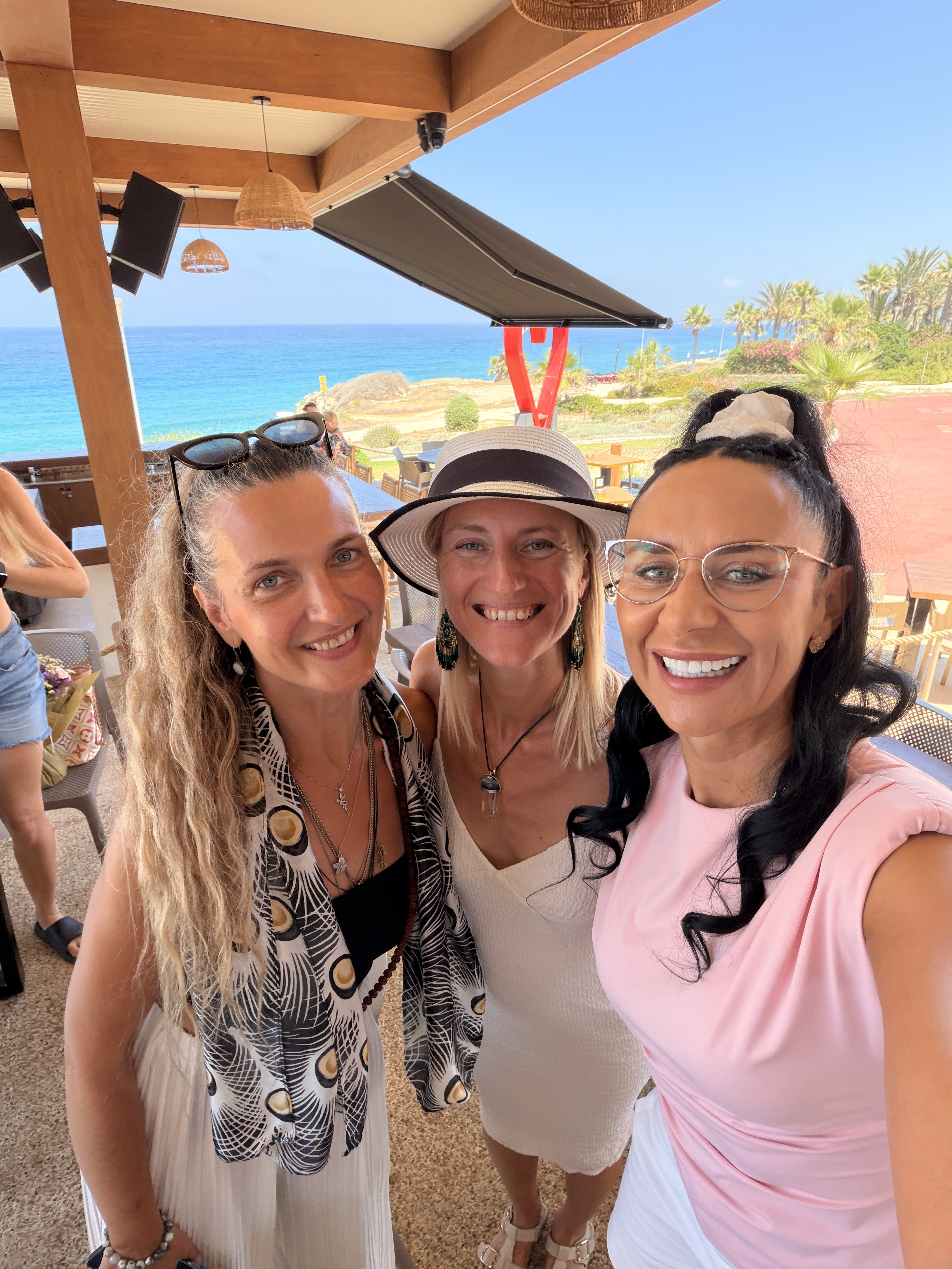 Anna with two members overlooking the sea in Paphos, 1 July 2026