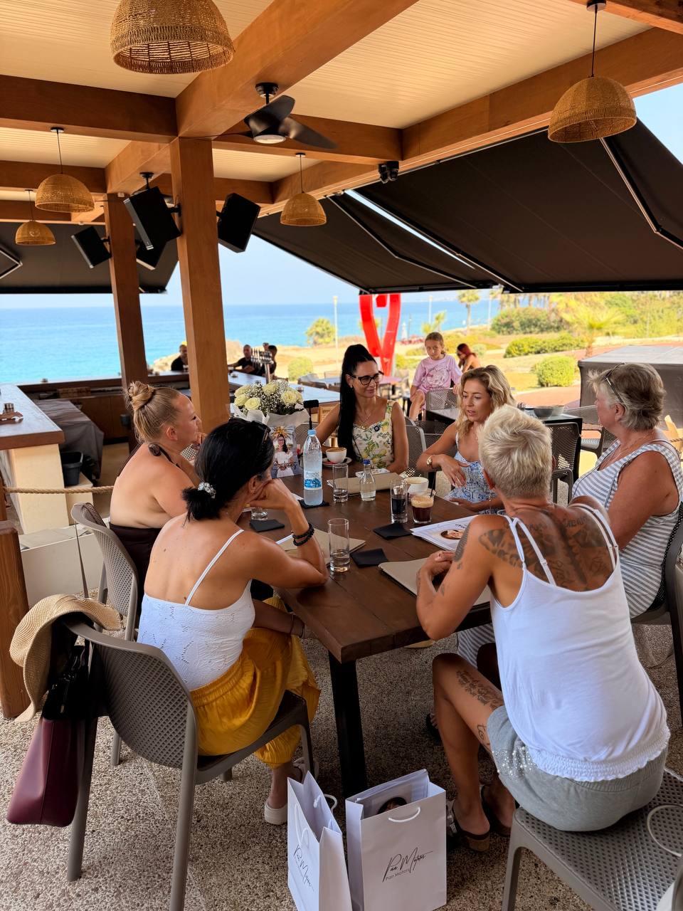 The women of WPA at the table overlooking the sea, 7 August 2026